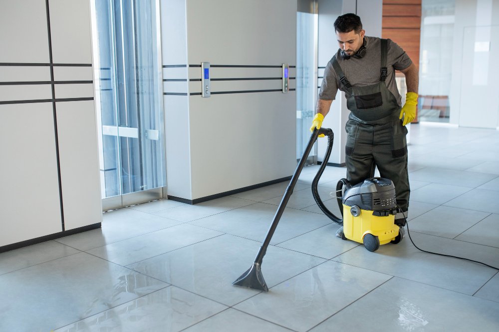 Office Cleaning man vacuuming